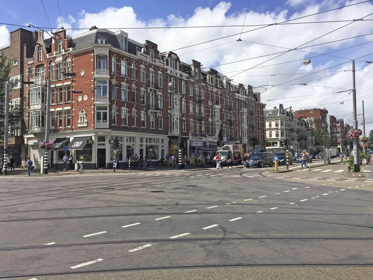 Straathoek met tramrails en statige panden in Amsterdam