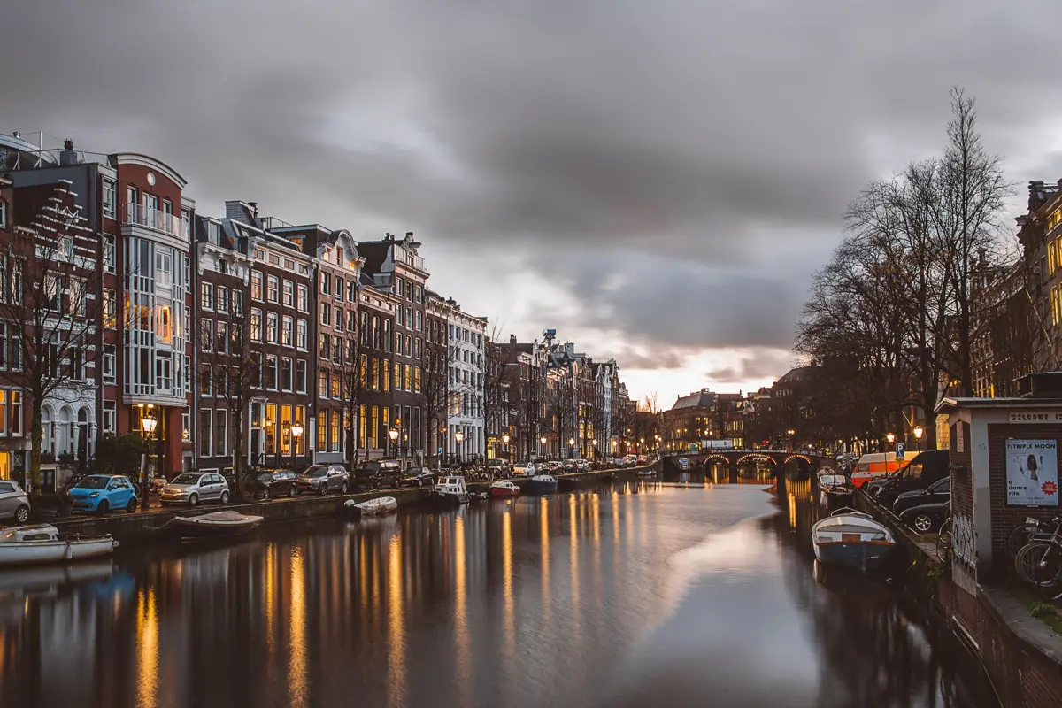 The Prinsengracht at dusk with lit windows reflecting in the canal