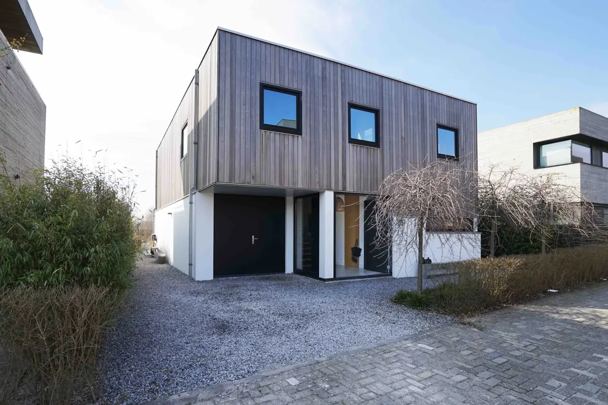 Modern family house with a wooden facade and its own driveway