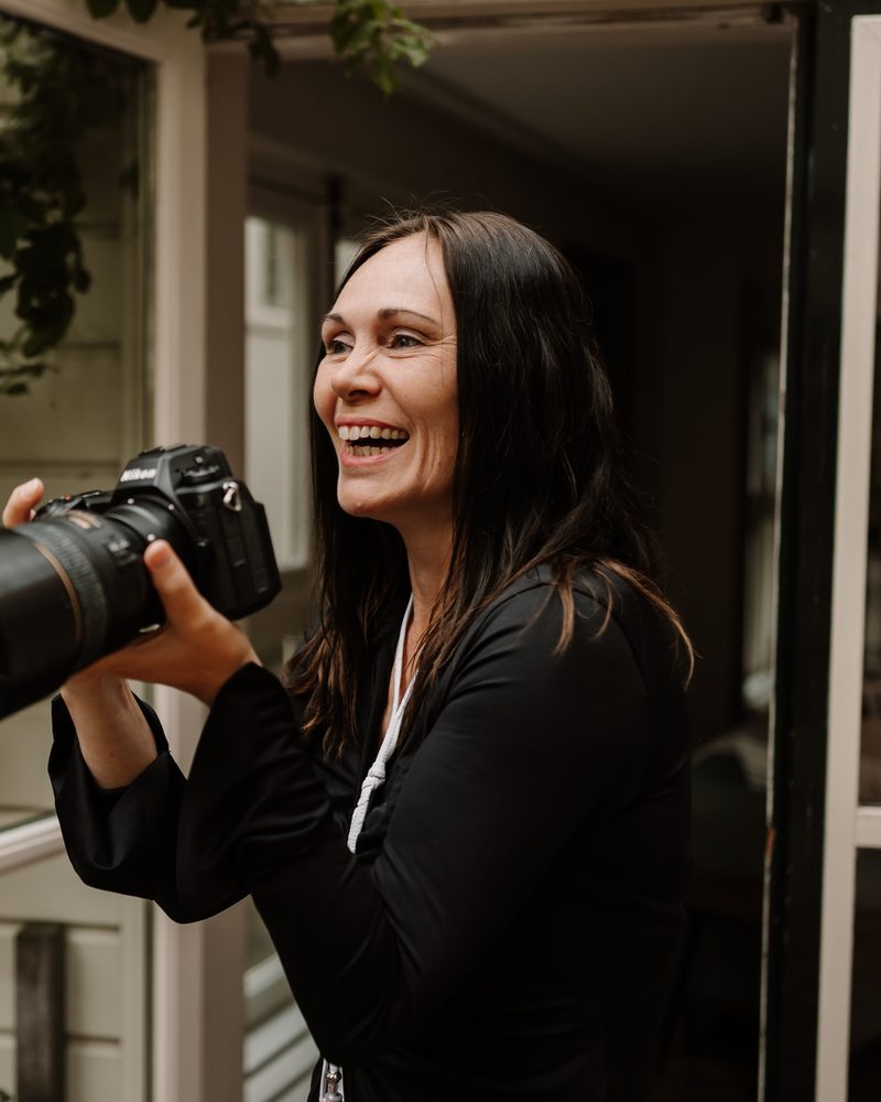 Hadewij with her camera, at work as a photographer
